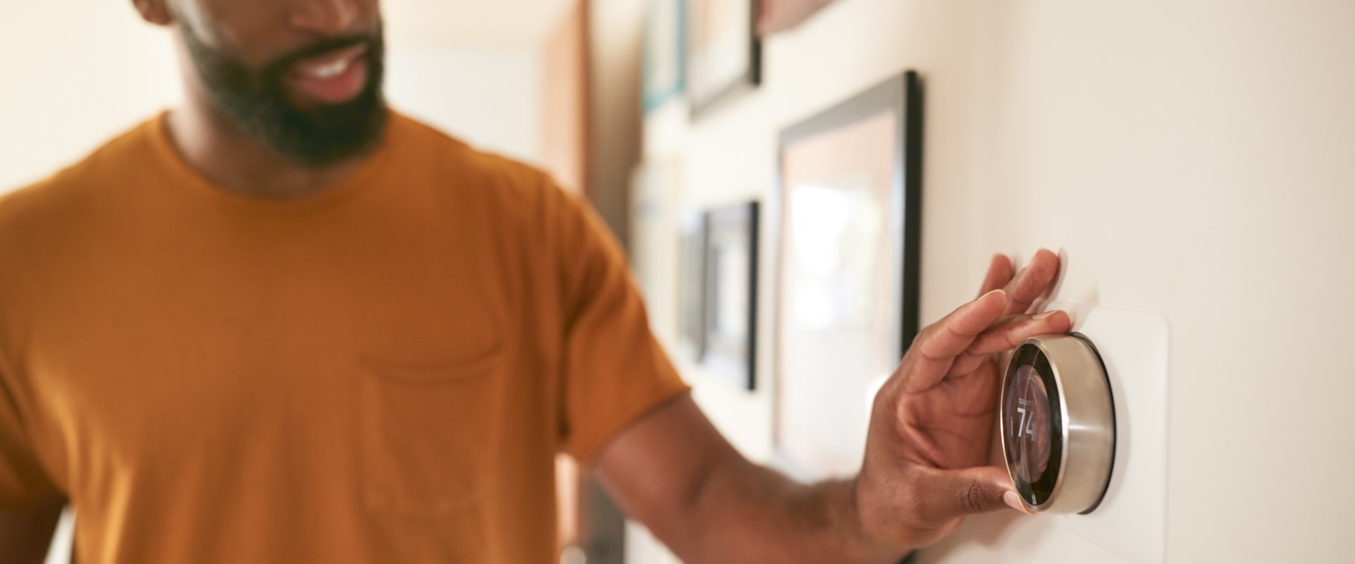 Homeowner adjusting smart thermostat